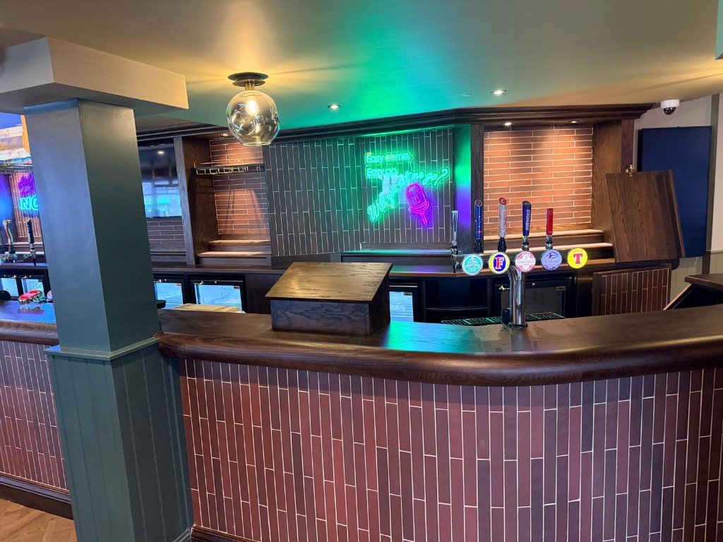 Completed — lounge banquette and neon feature wall