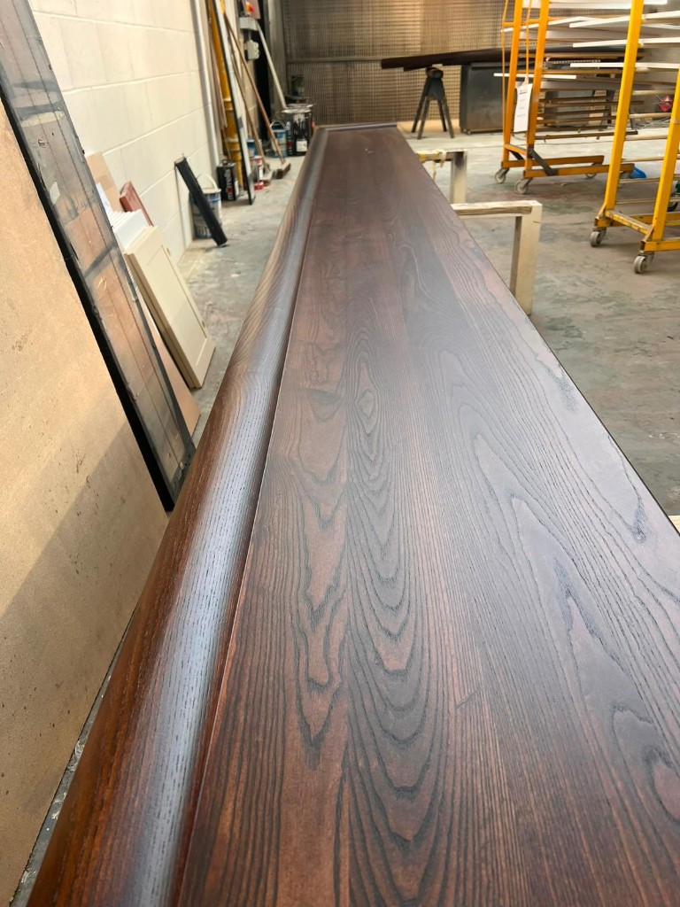Update 17 September — long stained oak bar top grain detail
