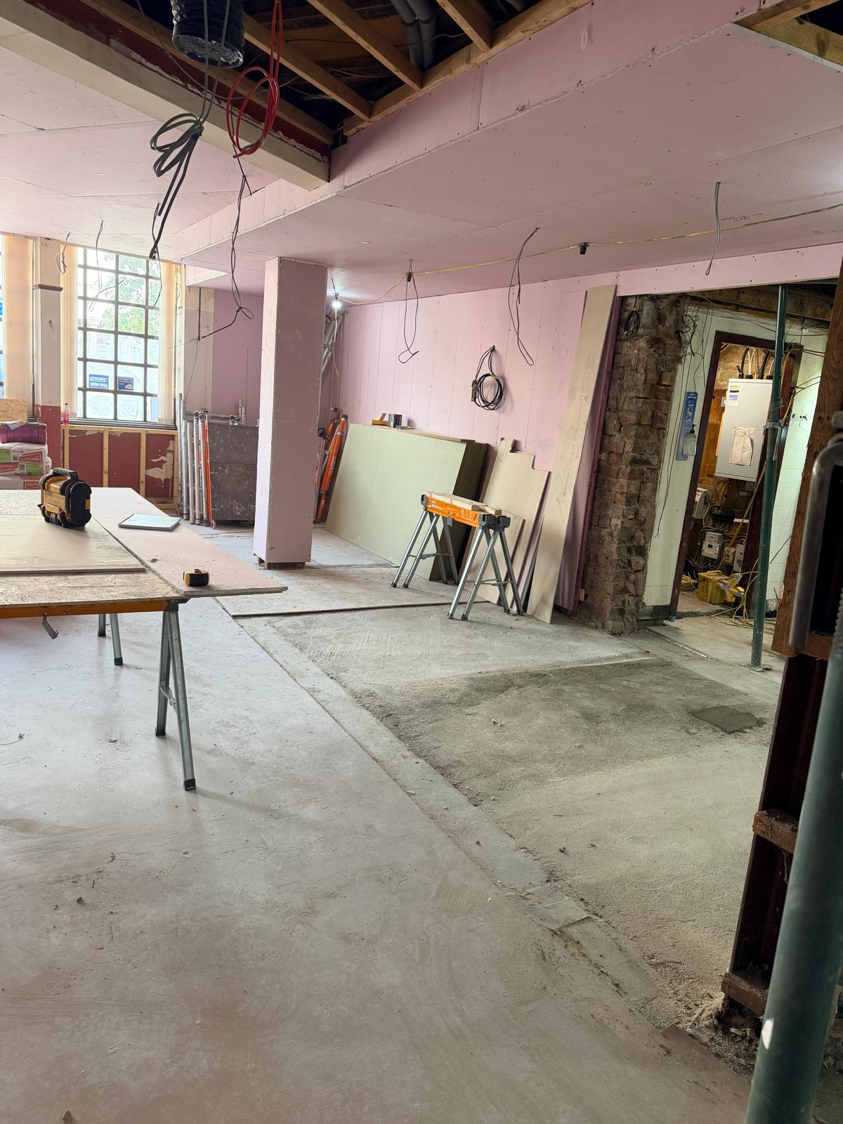 Update 24 July — boarded walls, concrete floor and site workbench